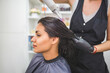 © Tania - Drying long dark hair with a hairdryer.