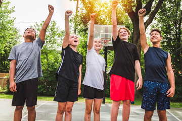 Wall Mural - great child Team in sportswear playing basketball game fist in the air