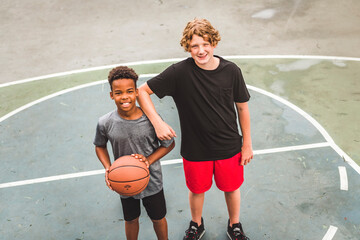 Wall Mural - two teens in sportswear playing basketball game