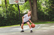 © Louis-Paul Photo - girl with basketball on court on summer season