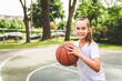 © Louis-Paul Photo - girl with basketball on court on summer season