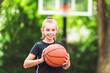 © Louis-Paul Photo - portrait of a kid girl playing with a basketball in park