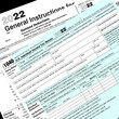 © Stone's Throwe Photo - 2022 IRS tax forms lay on a desk top.