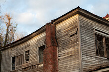 Old Wooden Weathered Dilapidated Abandoned Two Story House Roof And Chimney