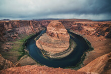Scenic View Of Horseshoe Bend Against Cloudy Sky