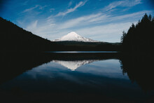 Scenic View Of Snowcapped Mountain Reflecting In Calm Trillium Lake