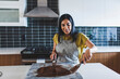© Cavan Images - Woman mixing chocolate sauce with spatula on marble in kitchen