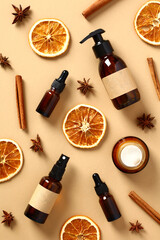 Wall Mural - flat lay amber glass bottles with natural cosmetics and dried orange slices, cinnamon sticks, anise 