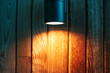 Outdoor wall lamp, facade lighting, spotlight with warm light in a night, copy space.