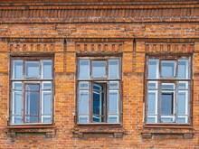 Three Windows Of The Old Mansion 19 Century With Brown Bricks Wall