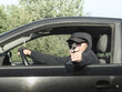 © bogdan vacarciuc - The man was shooting from the car. A man fires a gun from the car.