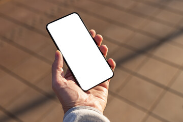 Aufkleber - Hand holding phone mockup on pavement background. Mobile app for city life. Application for finding application, food, events, housing. Smartphone template with white screen