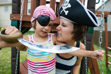 Mother And Daughter In Pirates Costumes Playing At Playground