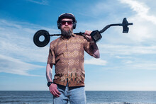 Portrait Of Man Holding Recreational Metal Detector At Horsey Beach Against Sky