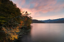 Scenic View Of Lake Chuzenji Against Sky During Autumn At Sunset