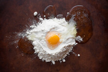 Overhead View Of Egg In Flour On Table
