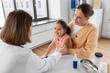© Syda Productions - medicine, healthcare and pediatry concept - female doctor or pediatrician disinfecting arm skin of little girl patient with mother at clinic