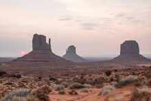 Scenic View Of Rock Formations On Desert Against Sky At Monument Valley During Sunset