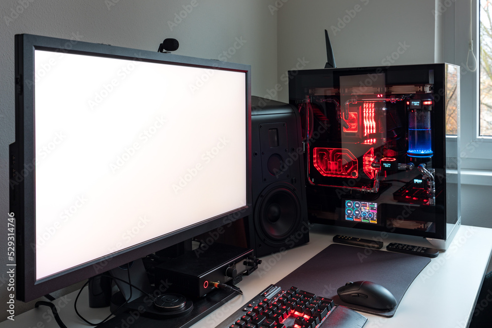 Powerful personal computer gamer rig with white screen. Professsional ...