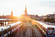 © Cavan Images - Trains moving on railway bridge against sky in city during sunset