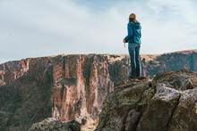 Woman Overlooking Rocky Cliffs
