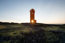 Sunlight Streaming Through Lighthouse Window Against Sky During Sunset At Iceland