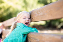 Girl By Fence With Big Smile