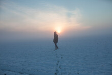 A Guy In A Winter Jacket Is Standing In A Snowy Field In Winter