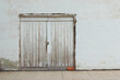 © Cavan Images - Old  white door on a white painted wall and a brown brick.