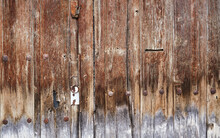 Green Padlock On Old Brown Wooden Door