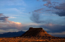 Sunset Turns Blue Hills Golden At The Foot Of Factory Butte.