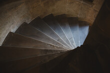 Looking Down A Spiral Stairway In A Castle