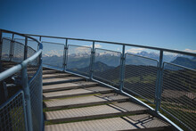 An Outdoor Spiral Staircase With Mountains In The Background