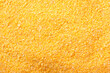 Raw cornmeal flour texture used in polenta on isolated background
