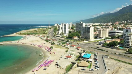 Wall Mural - Aerial view picturesque public beach with turquoise water. Los Corales, La Guaira, Venezuela.