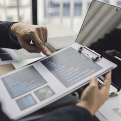 Wall Mural - Meeting a team of businessmen, Executives and accountants meeting about the company's revenue graph in the office with laptops and calculators, Finance concept.