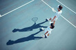 © David Lahoud/peopleimages.com - Sport, fitness and tennis player team discussion of game strategy while walking together on a tennis court from above. Professional, athletic and competitive man and woman planning and training