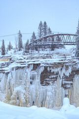 Wall Mural - View on the frozen waterfall of Chute-Aux-Galets on a snowy winter day near Saguenay, Quebec (Canada)