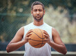 © David L/peopleimages.com - Basketball court, man and serious portrait with ball in outdoor sports venue for practice. Competitive, strong and mature athlete male thinking of a game play strategy for outside match.