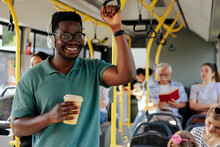 Black Man Having Coffee To Go In Bus