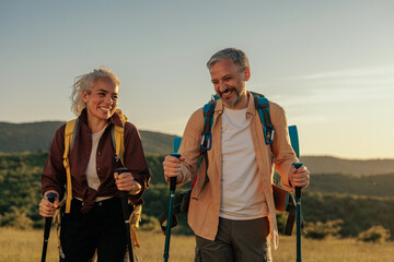 two middle age hikers bonding during a hike outdoors