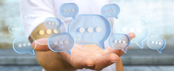 Wall Mural - Man touching with his fingers digital speech bubbles talk icons. Minimal conversation or social media messages floating in front of businessman hand. 3D rendering
