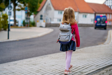 Cute little preschool girl o the way to school Healthy happy child walking to nursery school and kindergarten. Smiling child with backpack on the city street, outdoors. Back to school.