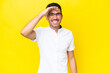 © luismolinero - Young handsome man over isolated yellow background looking far away with hand to look something