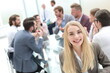 © ASDF - smiling young woman sitting near the table in the meeting room
