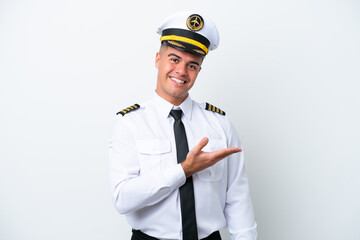 Poster - Airplane pilot caucasian man isolated on white background presenting an idea while looking smiling towards