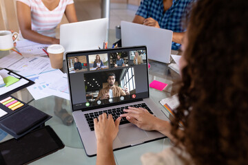 Poster - Biracial businesswoman in office making laptop video call with five diverse colleagues