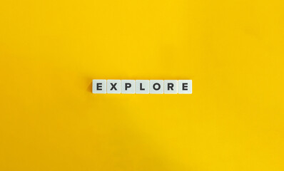 Wall Mural - explore word on block letter tiles on yellow background. minimal aesthetics.