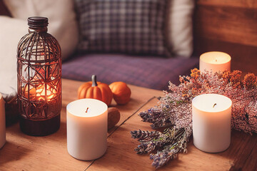 Wall Mural - Autumn hygge home decor arrangement, concept of hygge and coziness, burning white fragrance candle