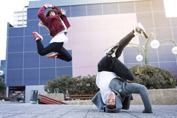 Young happy couple dancing on the street